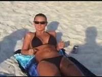 The lusty brunette noticed our camera man enjoying her body on the beach sand and she slid the bikini off her cool tits.