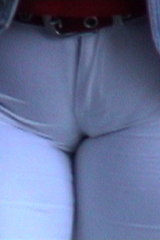 White pants with a bursting fat cameltoe